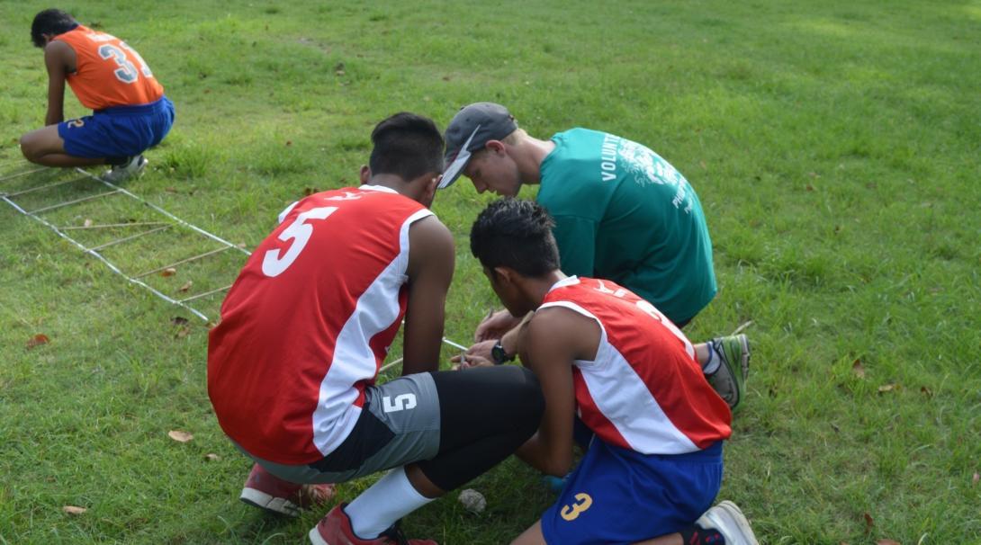 Volunteers set up a obstacle course while getting sports coaching work experience in the Philippines A football player volunteers with Projects Abroad as a sports coach in the Philippines